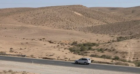 Camera track a car who is quickly moving on road in desert Negev at winter Stock-Footage 105898443