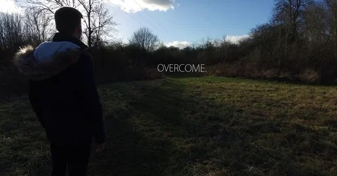 Camera tracking past young man with "Overcome" floating 3 Stock-Footage 73484042