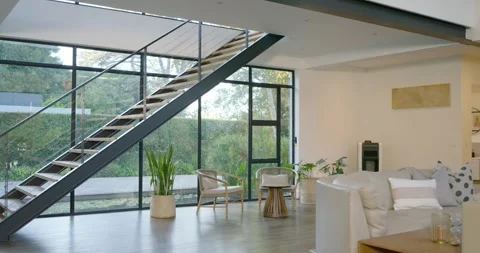 Camera is tracking right, revealing staircase and sofa, showcasing interior and Vídeos de archivo 340614046