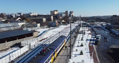 Camera tracking the train with a smooth rise above the town Stock Footage 222963655