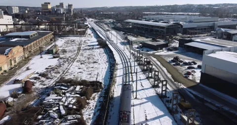 Camera tracking the train with a smooth rise above the town Stock Footage 222964605