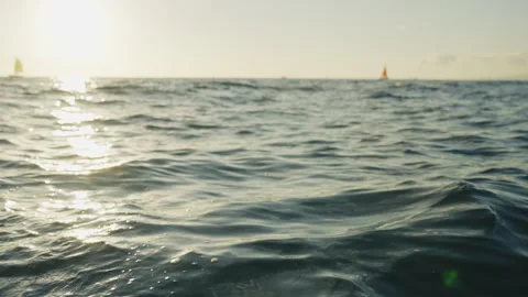 Camera Tracking from Waves to Sunset and Sail Boats in the Distance 4K Stock Footage 263282884