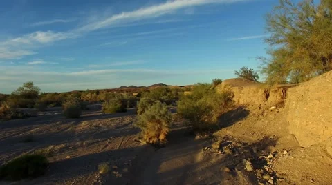 Camera tracks along canyon wall then climbs to reveal desert mountains 動画素材 58741791