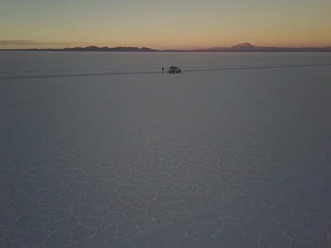 Camera tracks around pickup at sunset parked on the Salar de Uyuni salt flat Stock Footage 83292218