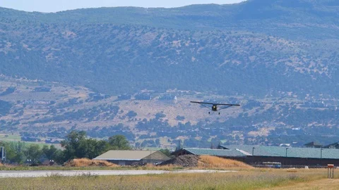 Camera tracks the black monoplane as it lands runway Video stock 116736053