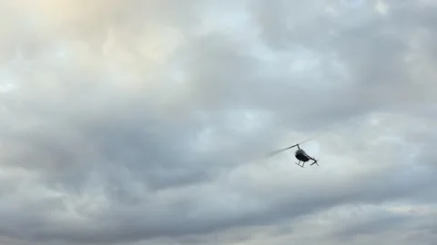 Camera tracks helicopter flying low over South African landscape Vídeo Stock 313319974