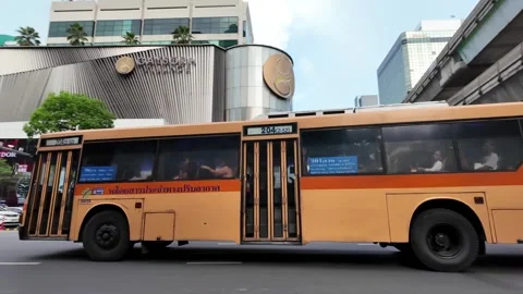 Camera tracks old Thai bus along Ratchadamri Road in ultra slow motion Stock Footage 300947726
