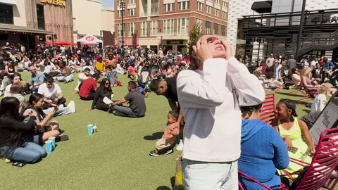Camera tracks through big crowd gathered to watch solar eclipse Stock Footage 271599092