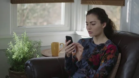 Camera tracks a young lady frustrated with her cell phone service Stock Footage 70808996