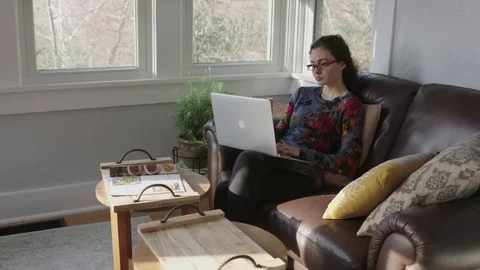 Camera tracks a young lady working on a computer Stock Footage 70809008