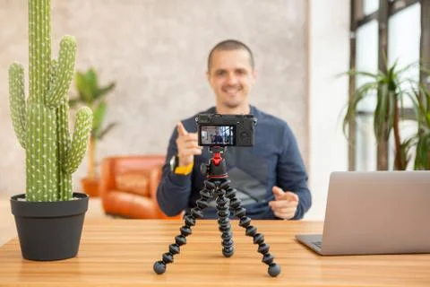 Camera on tripod and man filming hisself for video blog Stock Photos