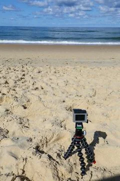 A camera is on a tripod on a beach Stock Photos