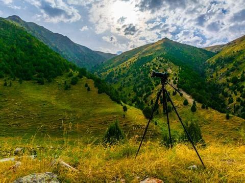 Camera on Tripod Capturing Mountain Landscape Vista in Kyrgyzstan 스톡 사진
