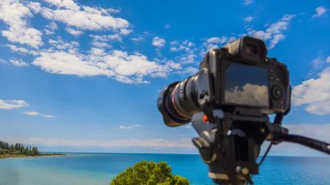 Camera on tripod capturing serene landscape in Kyrgyzstan 스톡 사진