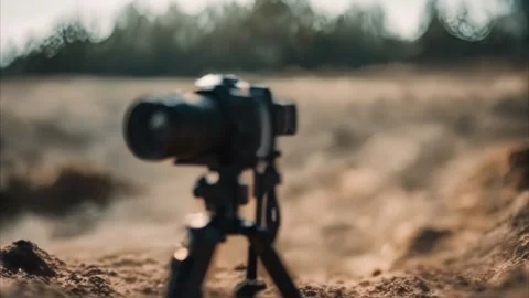 Camera on Tripod in a Dusty Landscape Stock Footage 284741979