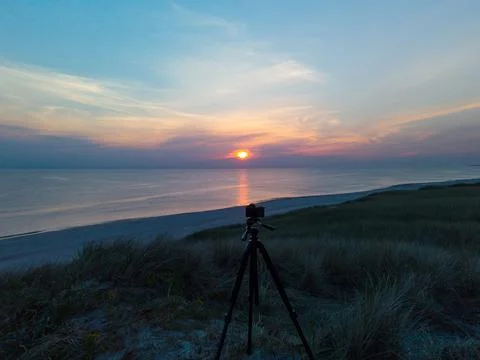 Camera on tripod recording sunset Stock Photos