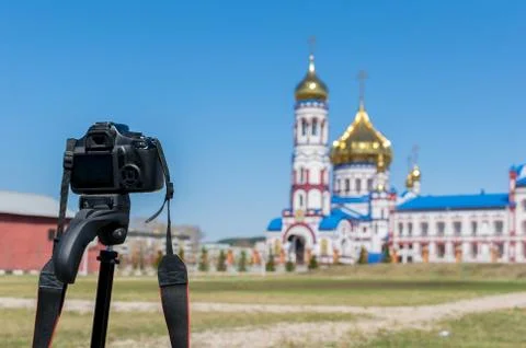 Camera on a tripod shoots a large Church Cathedral Stock Photos