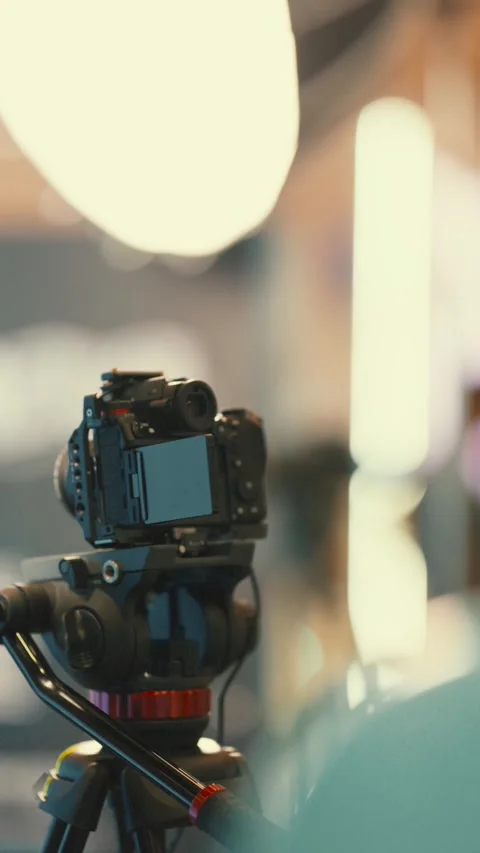 Camera on tripod in a studio setup for recording and capturing images at a Video stock 338242814