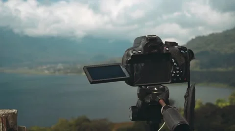 Camera on tripod taking pictures of Buyan Lake and mountain, slide Stock Footage 68064422
