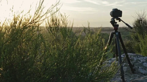 Camera on Tripod on Top of a Hill at Sunset Stock Footage 105258556