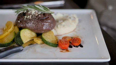 Camera turns around filet mignon dish Stock-Footage 94235330