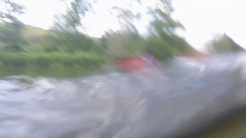 Camera under water rising seeing passing group in kayaks and canoes Stock Footage 90142082