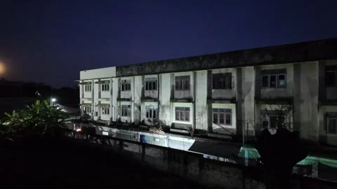 Camera video of abandoned building at night with full moon in background Stock Footage 325648952