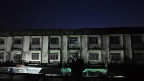 Camera video of abandoned building at night with full moon in background Stock Footage 325648953