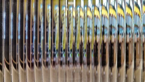 Camera video of abstract reflections on vertical metal pipes or panels Stock Footage 325649675