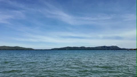 Camera video of calm sea with blue sky and distant islands Stock Footage 325650211