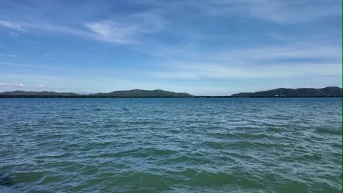 Camera video of calm sea with blue sky and distant islands Stock Footage 325650227