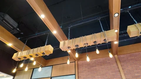 Camera video of ceiling with decorative hanging lights in a café interior 스톡 동영상 325648902