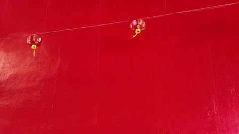 Camera video of Chinese lanterns hanging on red wall Stock Footage 325650553