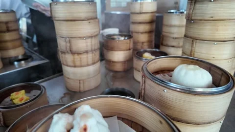 Camera video of dim sum served in bamboo steamers Stock Footage 325720576