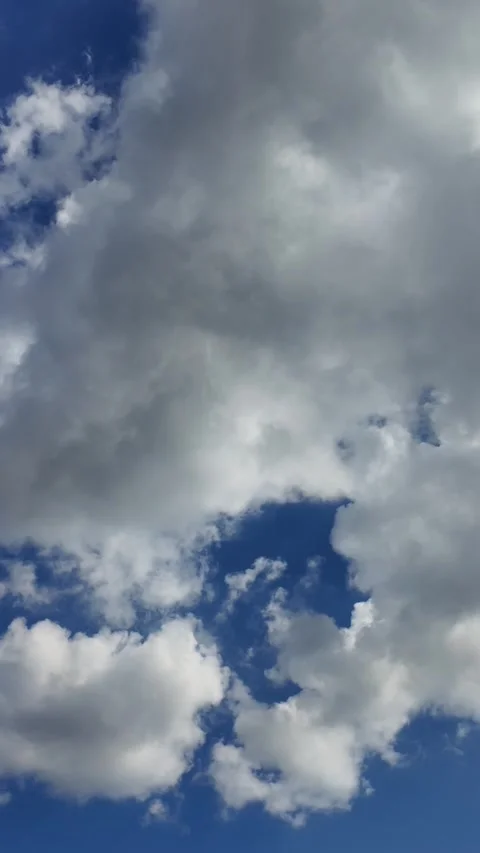 Camera video of dramatic clouds moving across blue sky Stock Footage 325650271