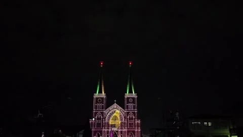 Camera video of fireworks exploding above illuminated cathedral at night Stock Footage 325560061