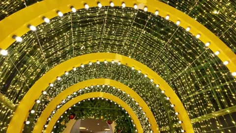 Camera video of glowing Christmas light tunnel with ornaments Stock Footage 325560426