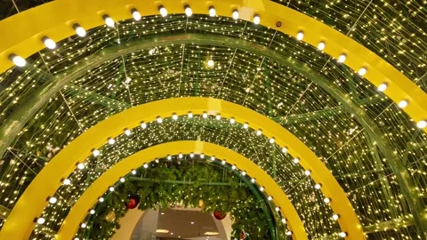 Camera video of glowing Christmas light tunnel with ornaments Stock Footage 325560500