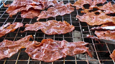 Camera video of grilled dried meat on charcoal stove Stock Footage 325650559