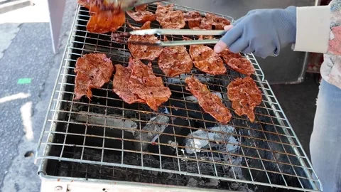 Camera video of grilled dried meat on charcoal stove Stock Footage 325650570