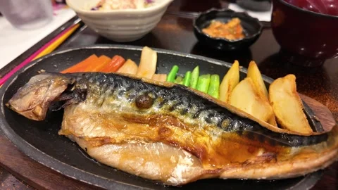 Camera video of grilled mackerel fish on hot plate Stock Footage 325560735