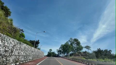 Camera video of mountain road and blue sky on a sunny day Stock Footage 325650180