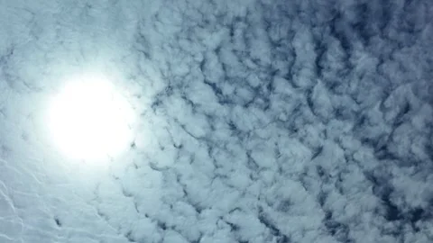 Camera video of textured clouds in the sky with bright sunlight Stock Footage 325648886