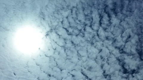 Camera video of textured clouds in the sky with bright sunlight Stock Footage 325648894