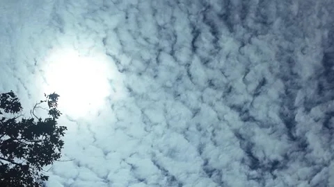 Camera video of textured clouds in the sky with bright sunlight Stock Footage 325648896
