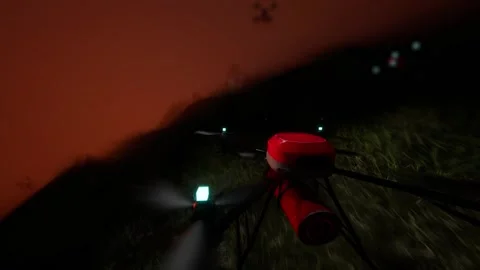 Camera view from the background of a drone flying towards a fire in nature.  Stock Footage 282223266