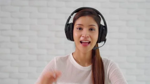 Camera view of Happy young asian business woman wears headset talk to online  Video stock 134306666