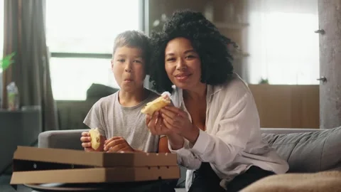 Camera view of little boy kid and mother mom watching movie together Stock Footage 248690154