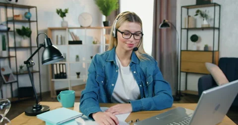 Camera view on smiling pretty skilled young blond woman in glasses and Stock Footage 158483152