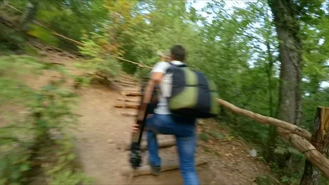 The camera watches as a man climbs the mountain path. Stock-Footage 84787514